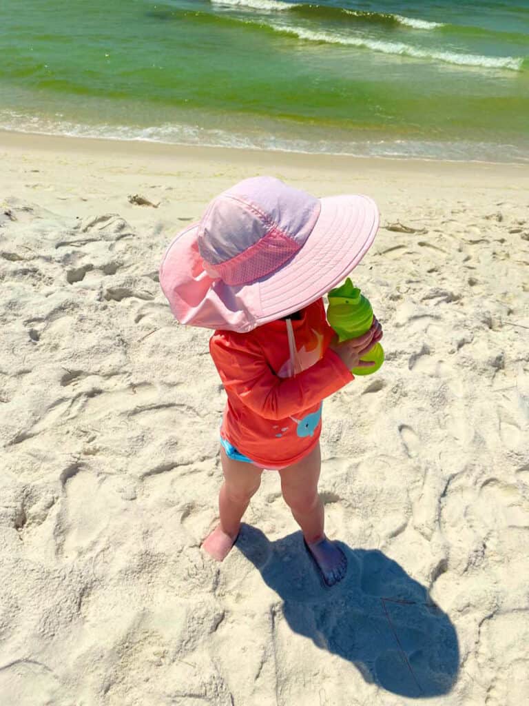 Toddler exploring beach- travelling to beach with young kid