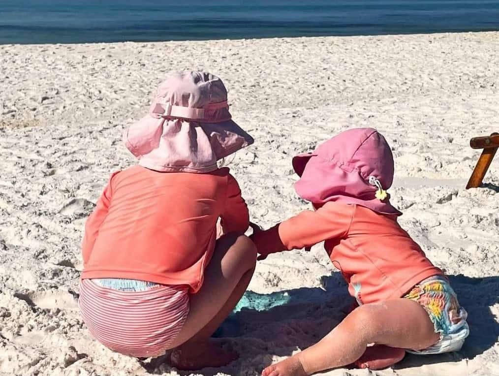 Baby and preschooler playing on the beach in the Florida panhandle