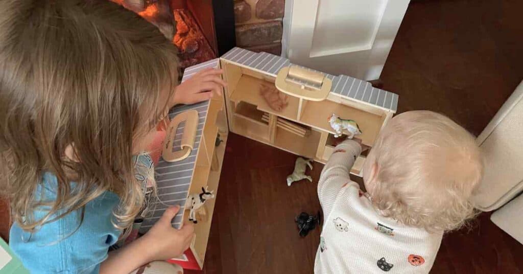 Siblings (a baby and a preschooler) playing together
