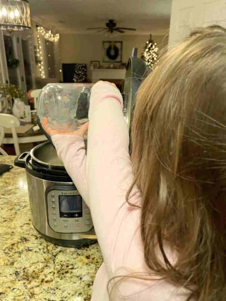 Preschooler pouring milk into an instant pot