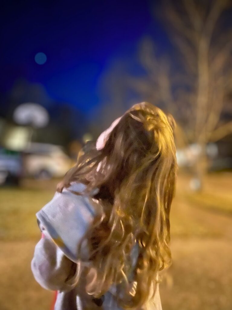 Preschooler gazing up at winter night's sky