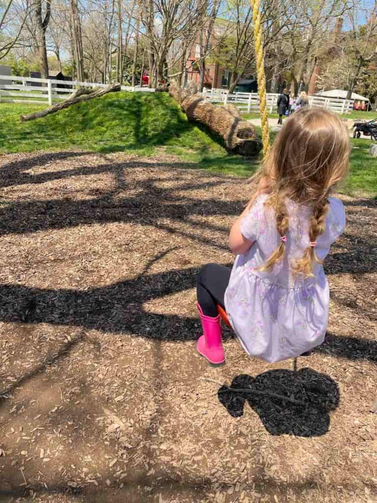 preschooler playing on a natural playground at Shaker Village of Pleasant Hill
