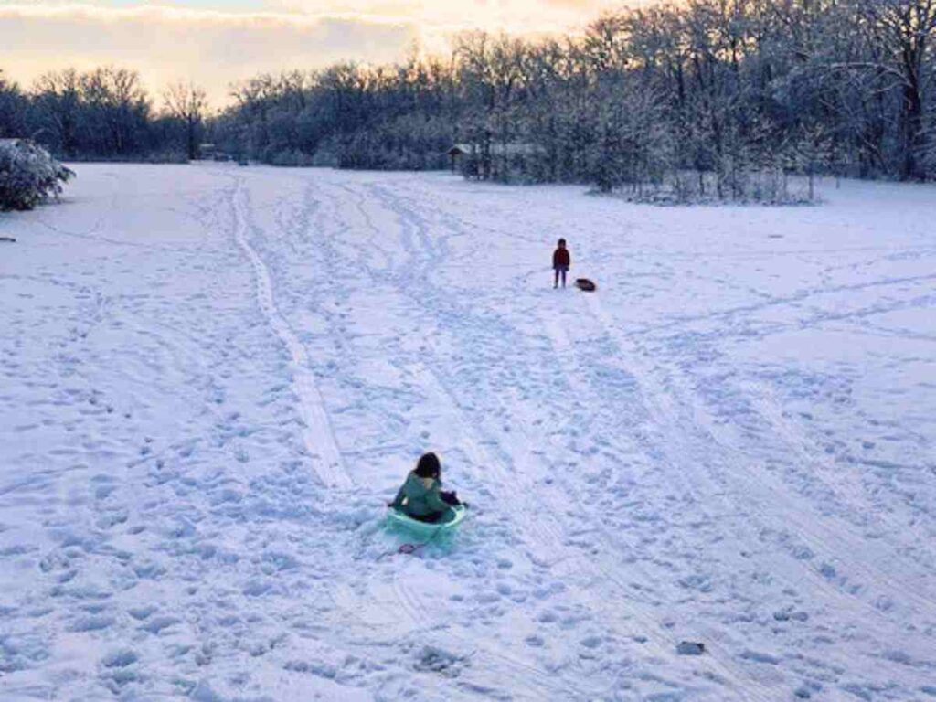 Kids sledding in the snow