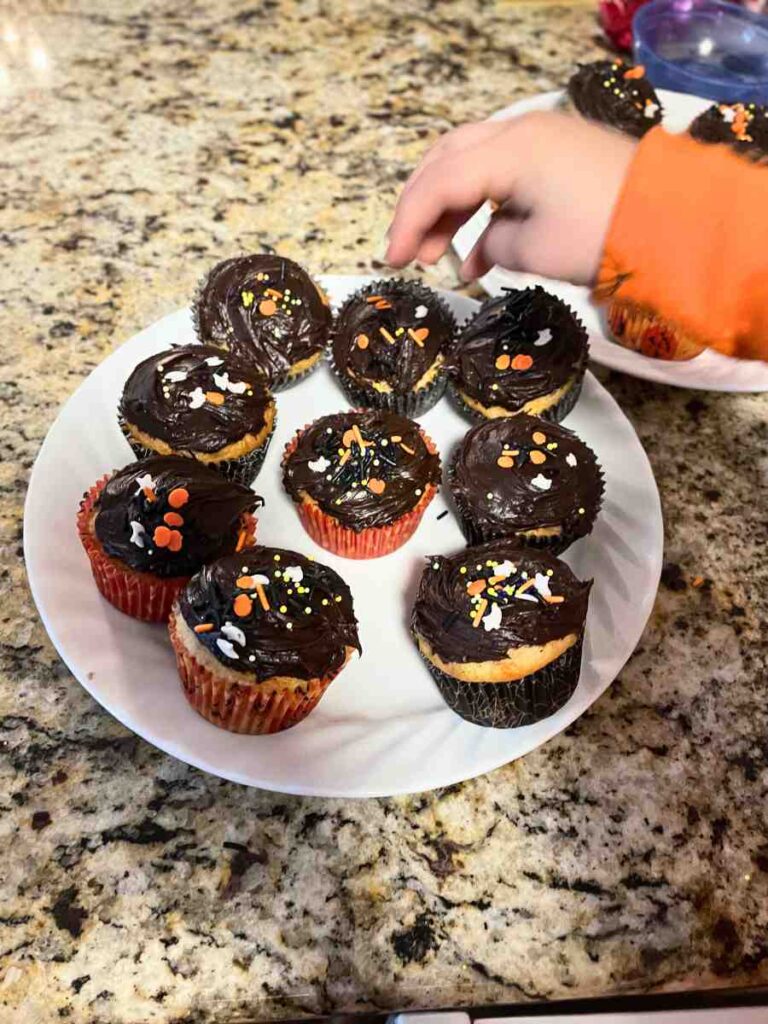 Preschooler Decorating Halloween Cupcakes