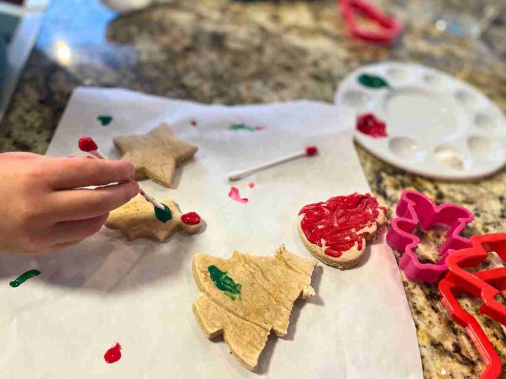 preschooler painting salt dough ornaments