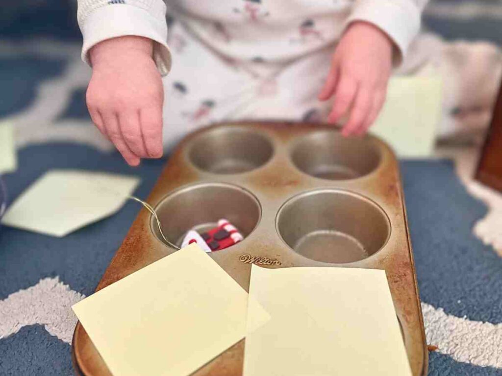 Toddler with a Christmas Muffin Tin Surprise Montessori Activity 