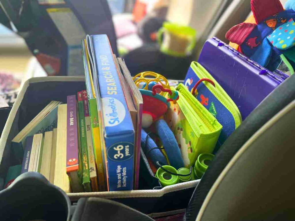 Backseat organizer full of games and books for a family road trip